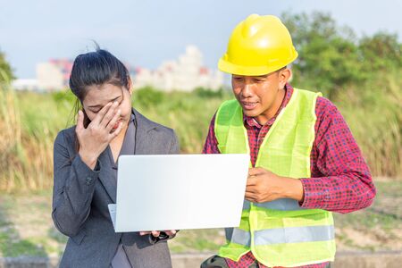 Businesswomen and foreman talking together and happy funny. Engineer and manager teamwork and checking at site construction .の写真素材