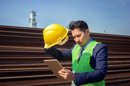 Engineer use tablet for test and checking at industry in midday and hot weather. Working concept.の写真素材