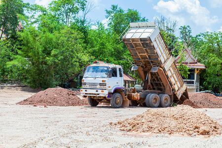 Dump truck is moving down soil on construction site.の写真素材