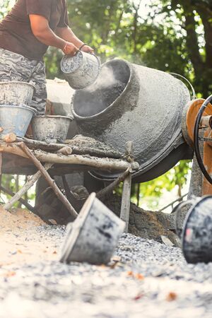 The workers are mixing cement in a cement mill.の写真素材