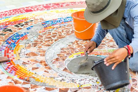 Plasterer spreading plaster on the ground.の写真素材