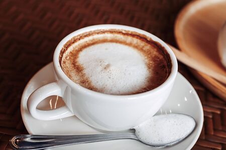 hot cup of coffee on the wood table in the morning.の写真素材