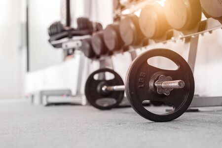 A set of heavy barbells on a gym floor.の写真素材