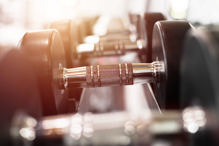 Close up dumbells set for a exercise in the fitness gym.