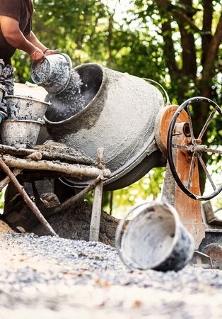 The workers are mixing cement in a cement mill.の写真素材