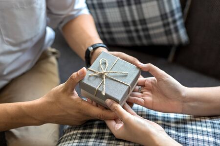 christmas, valentine, holidays gift box concept. Couple surprise gift box together.の写真素材
