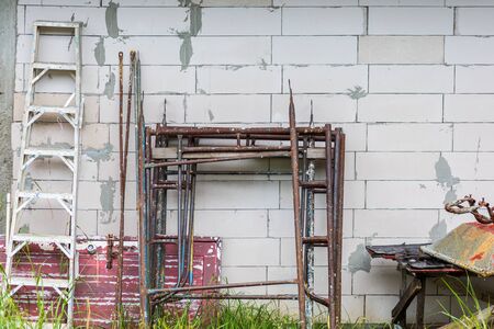 Scaffolding and Cement cart on the ground near the wall at site construction.の写真素材