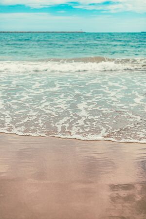 Beach sea water flow with blue sky. Seascape wallpaper.の写真素材