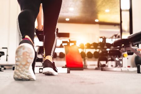A women wear sport shoes.
Full length portrait of a athletic  women stretching at sport gym.の写真素材