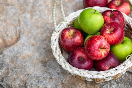An Apple in basket and on the ground.の写真素材