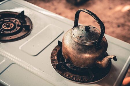 Old kettle on gas stove in kitchen.の写真素材