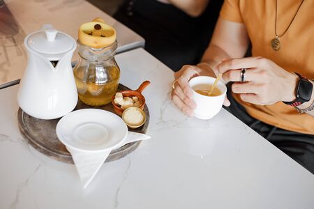 Hand use spoon mix sugar and tea water.の写真素材