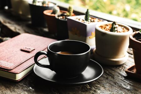 coffee cup on the table near book in the morning.の写真素材