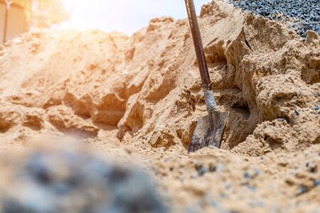 construction site with shovel on pile of  sand.の写真素材