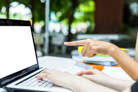 Hand pointing at blank screen of laptop. Using computer pcの写真素材