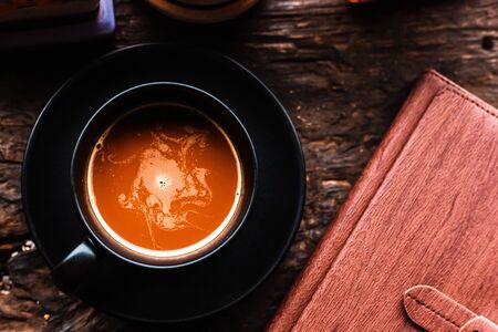 coffee cup on the table near book in the morning.の写真素材