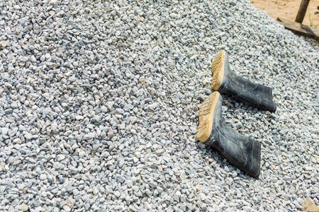 Boots on gravel at site construction.の写真素材