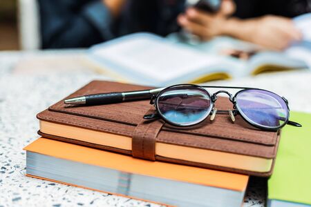 Glasses and pen on the book.の写真素材