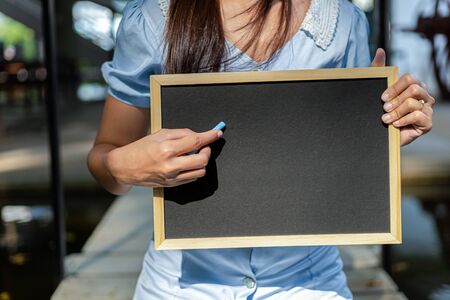Hands use chalk for drawing, writing balckboard in the parks. Education, learning concept.の写真素材