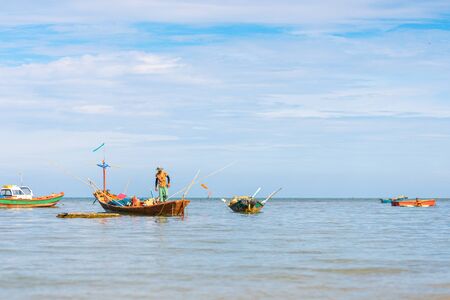 fishing boat on the blue water and blue sky.の写真素材