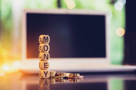 wood cube word "money" on coin.の写真素材