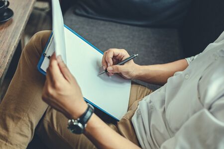 Businessman hold pen and working.  Business office concept.の写真素材