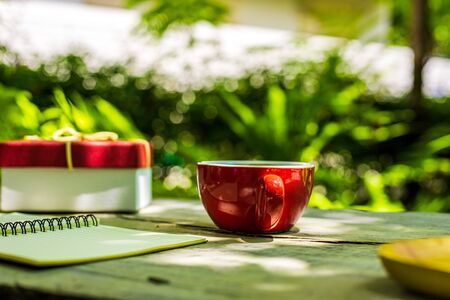 Coffee cup on the table near paper short note.の写真素材