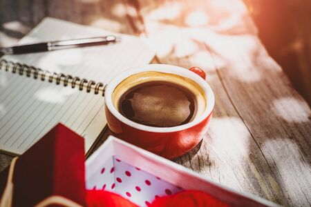 Coffee cup on the table near paper short note.の写真素材