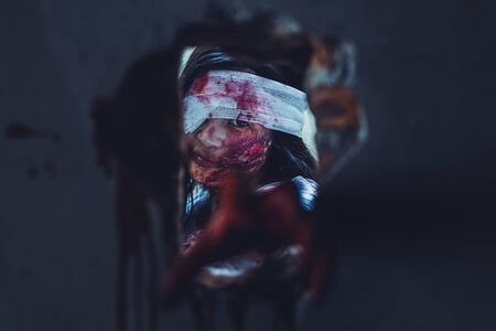horror scence of woman with scary hand  at abandoned house. hand through the hole wall. Halloween conceptの写真素材