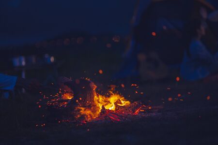 Burning wood at night. Campfire at nature in mountains. Flame and fire sparks. abstract background. の写真素材