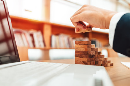 Ant eye view Male hand stacking wooden blocks. Business development and growth concept