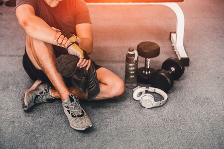 muscular caucasian young  man taking a break relax  after workout for good healthy in fitness gym. sport exercise conceptの写真素材