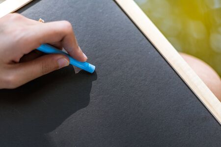 Hands use chalk for drawing, writing balckboard in the parks. Education, learning concept.の写真素材