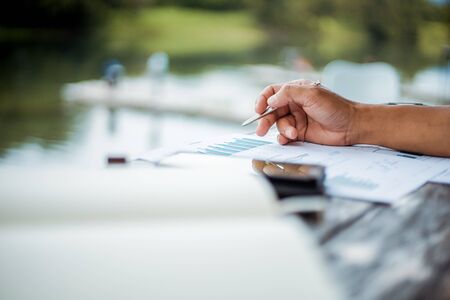 Businessman use stylas pen for writing mobile phone.の写真素材