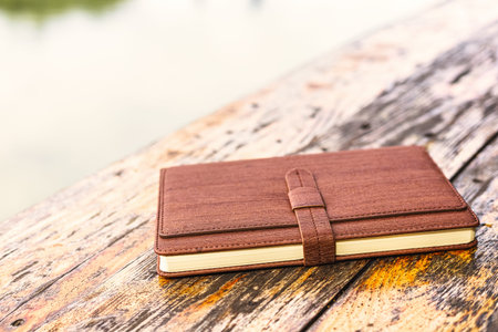 A diary on old wood table.