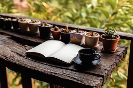 coffee cup on the table near book in the morning.の写真素材