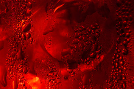 Drops of water on red metallic surface. Macro photo ,close up drop water on red background