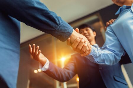 Business shaking hands, finishing up meeting. Successful businessmen handshaking after good deal.の写真素材