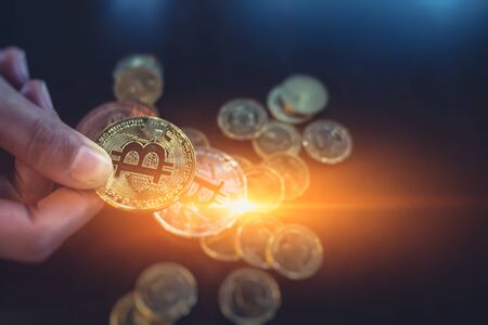 man is  hand holding golden Bitcoinの写真素材
