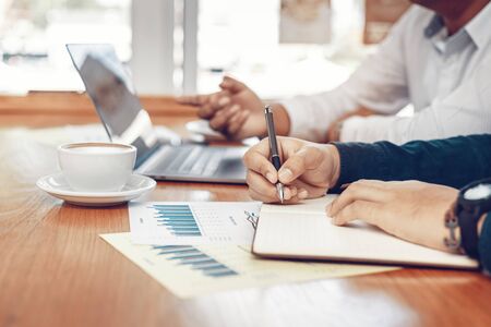 Businessman working and meeting together in the office. Hand writing note and calculate data.の写真素材