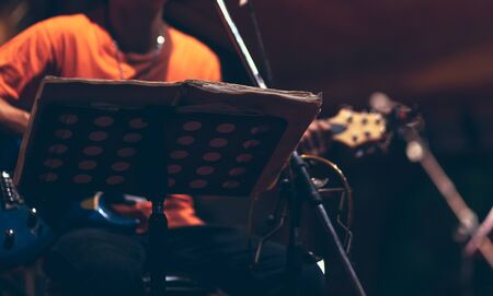 man hand playing guitar acoustic and singing on the stage at night.の写真素材