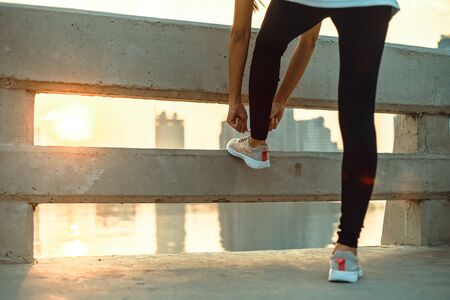 Woman tying shoe laces. の写真素材