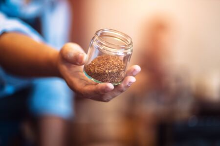 Barista show coffee beans in drip glass.の写真素材