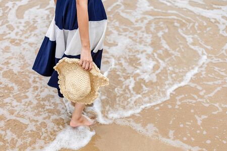 Happy young girl walking on the beach. Summer travel, vocation, holiday concept.の写真素材