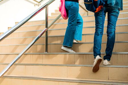 college student walking up the staircaseの写真素材