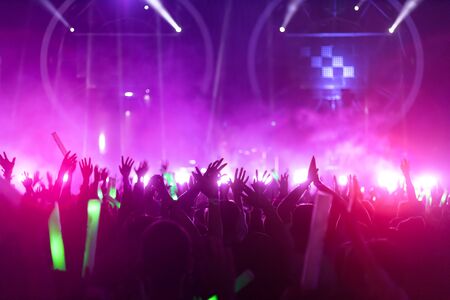 crowd with raised hands at concert festivalの写真素材