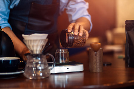 remove the beans from the bottle with a measure spoon.Measuring coffee drip with glass mug