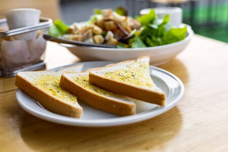 Tasty bread with garlic  on kitchen table.の写真素材