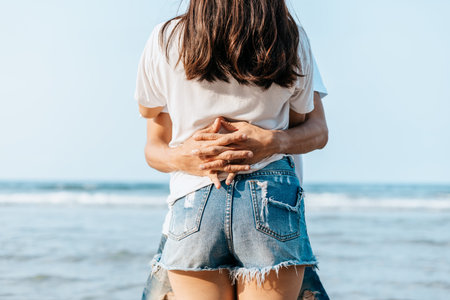 Romantic couple having love and hug on the beach.