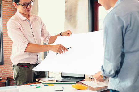 industry manager and engineer, businessman reading and checking blueprint, drawing  in the room